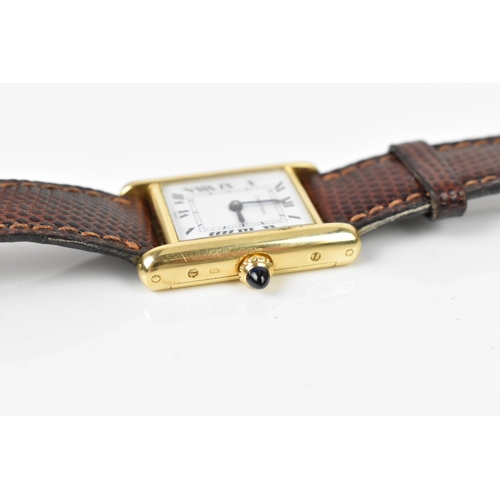 26 - A Cartier Tank, manual wind, ladies, 18ct gold wristwatch, having a white dial with Roman numerals, ... 