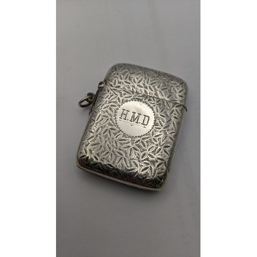 109 - A silver floral vesta cast having engraved initials together with two mother of pearl card cases A/F... 