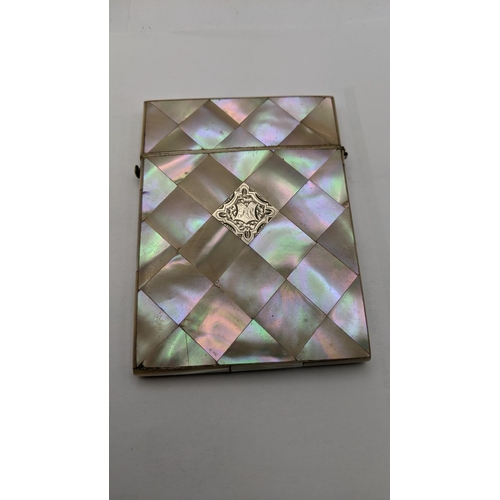 109 - A silver floral vesta cast having engraved initials together with two mother of pearl card cases A/F... 