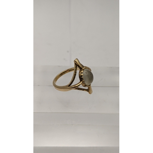 123 - A gold coloured ring set with a tigers eye, a 9ct gold ring set with a moon stone an a white gold ri... 