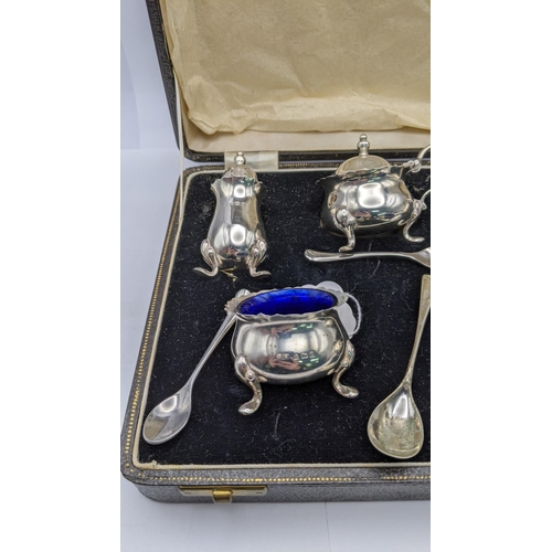 155 - A silver condiment set comprising of two salts, two peppers and a mustard and silver plated spoons
L... 