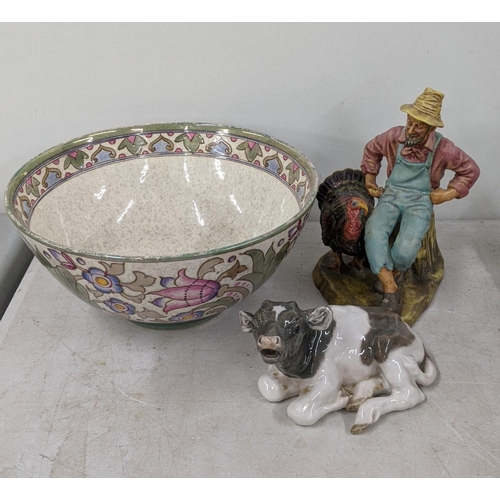 245 - A Royal Copenhagen 1072 resting cow A/F, along with a Royal Doulton 2446 'Thanks Giving man and his ... 