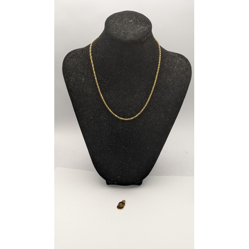 33 - A yellow metal necklace tested as 9ct gold together with a 10ct gold pendant stamped 10k total weigh... 