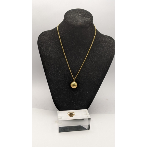 34 - a 18ct gold pendant fashioned as a sea shell 1.2g on a 9ct gold necklace, along with a ladies 9ct go... 