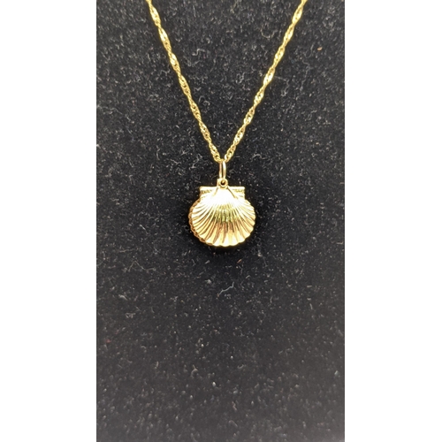 34 - a 18ct gold pendant fashioned as a sea shell 1.2g on a 9ct gold necklace, along with a ladies 9ct go... 