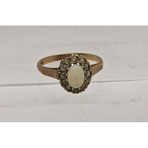 43 - A 9ct gold ring inset with a central opal, surrounded by paste stones, total weight 2.3g
Location: R... 
