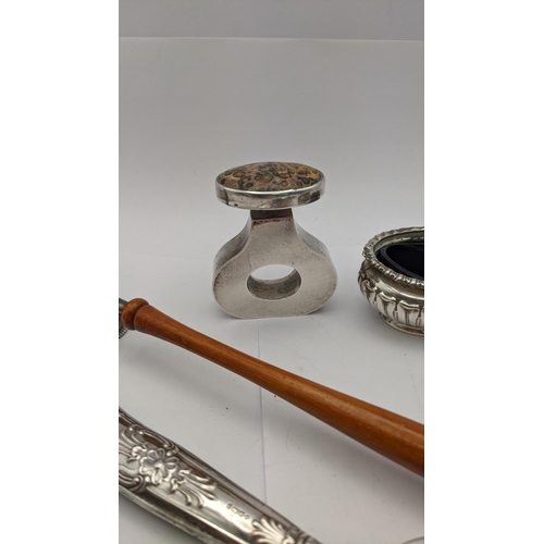 79 - A pair of silver embossed condiments, a silver snuffer, together with a white metal Mexican scent bo... 