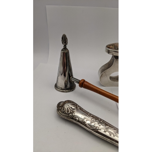 79 - A pair of silver embossed condiments, a silver snuffer, together with a white metal Mexican scent bo... 