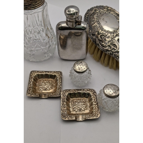 82 - Silver comprising two ashtrays, a hairbrush, a salt and pepper, a sugar caster and a silver plated s... 