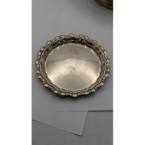 87 - Mixed silver to include a pierced one footed dish, a silver pin tray along with a floral embossed ve... 