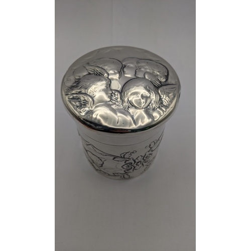 98 - A silver lidded dressing table jar having floral embossed decoration with angles, together with a ma... 