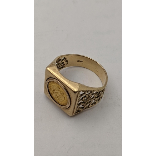 17 - A yellow metal gents ring with a pierce design famed with a Does Pesos coin the ring stamped 14k, 8.... 