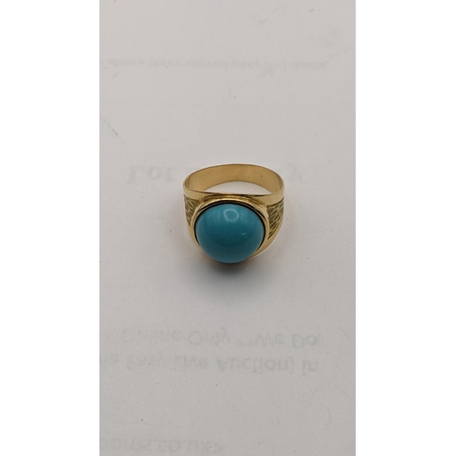 23 - A yellow metal ring set with a circular turquoise tablet 5.3g
Location: CAB3