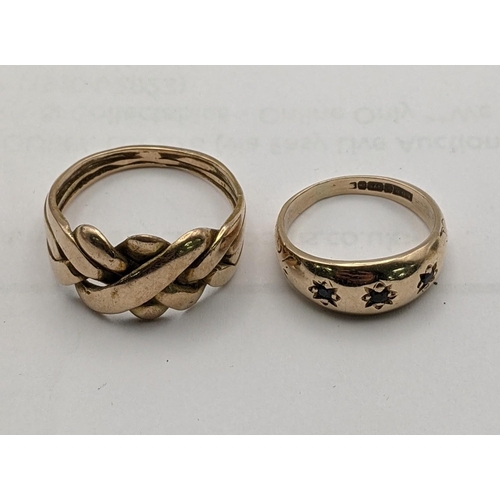 24 - Two 9ct gold rings, one puzzle ring and a gypsy ring set with three non precious stones 7.7g
Locatio... 