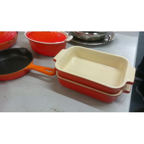 241 - Le Creuset pots and pans to include a frying pan, serving dish and others, mostly in orange
Location... 