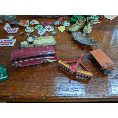 273 - A mixed lot of 1960s cloth and metal boy scout badges, diecast Dinky Toy vehicles including a boxed ... 