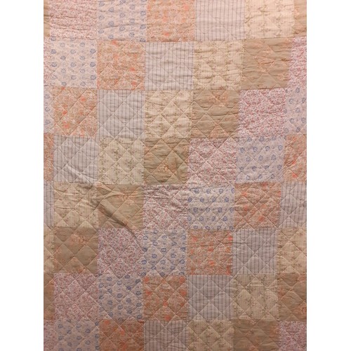 123 - A late 20th Century patchwork quilt in pale greens, blues, pinks and peach colours with floral and g... 