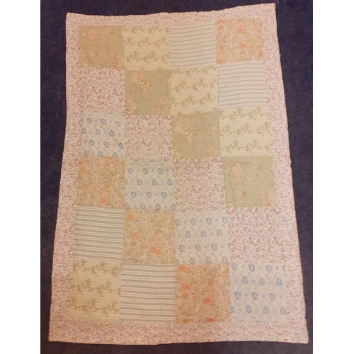 123 - A late 20th Century patchwork quilt in pale greens, blues, pinks and peach colours with floral and g... 