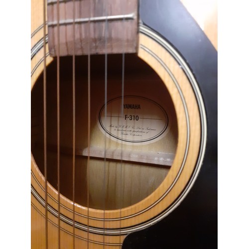 195 - A Yamaha F-310 6-string acoustic guitar with soft padded case.
Location: RWF