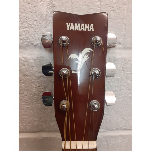 195 - A Yamaha F-310 6-string acoustic guitar with soft padded case.
Location: RWF