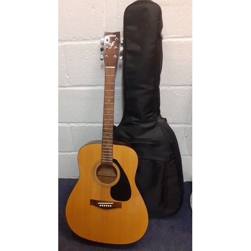 195 - A Yamaha F-310 6-string acoustic guitar with soft padded case.
Location: RWF