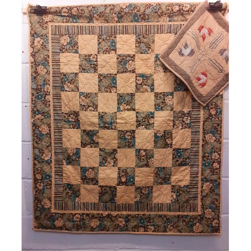 124 - A 20th Century handmade quilt in browns, cream, white, pinks, greens and blues having a geometric sq... 