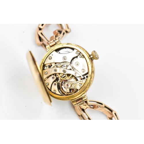 18 - An early 20th century, manual wind, ladies 14ct gold wristwatch, having a white enamel dial with blu... 