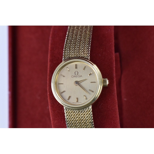 19 - An Omega, quartz, ladies, 9ct gold wristwatch, having a gilt dial with baton markers and integral me... 