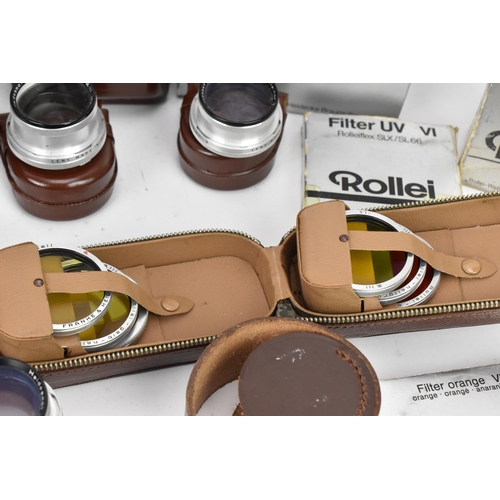 238 - A collection of Rollei lenses and filters, to include bay III lens filters in a leather case, UV-fil... 