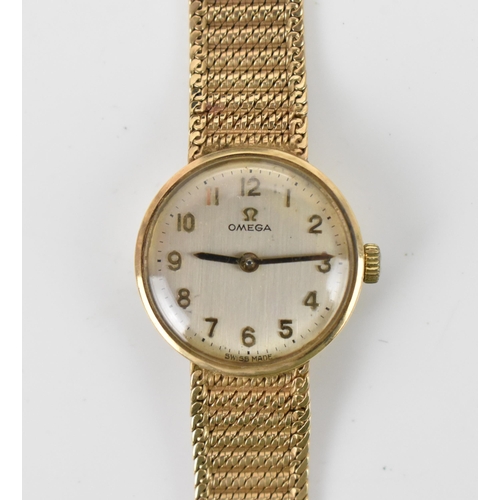 3 - An Omega, manual wind, ladies, 9ct gold vintage wristwatch, having a silvered dial, Arabic numerals ... 