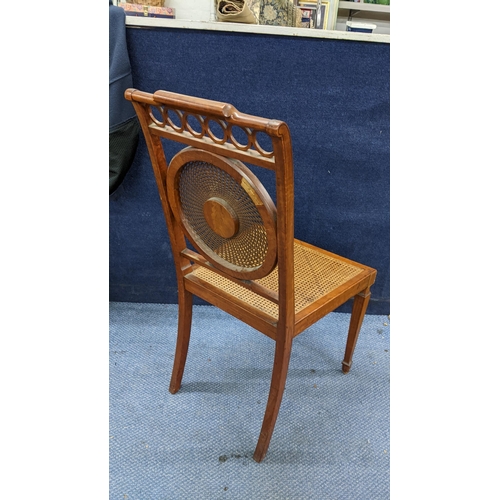 479 - An Edwardian satinwood Sheraton Revival side chair having Adams style decoration, having a caned bac... 