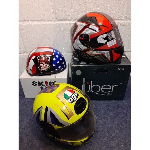 457 - Three decorative helmets to include Skid Lid and Uber for decoration only, all with original boxes
L... 