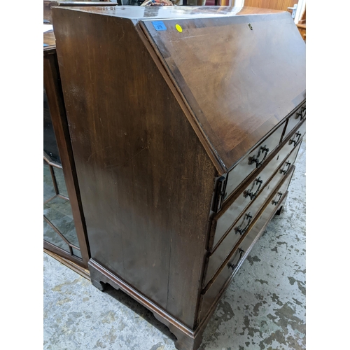 371 - A Georgian mahogany cross banded bureau, fall flap with fitted pigeonhole and drawer interior, above... 