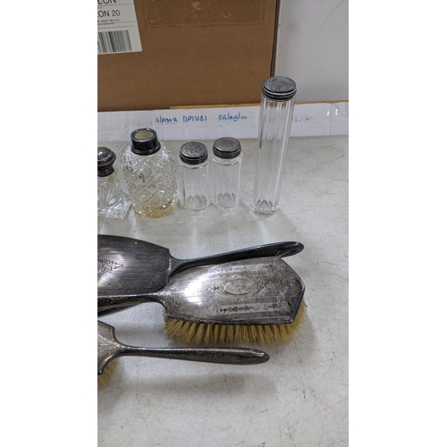 370 - A mixed lot of silver to include dressing table brushes, jars, and other items Location: