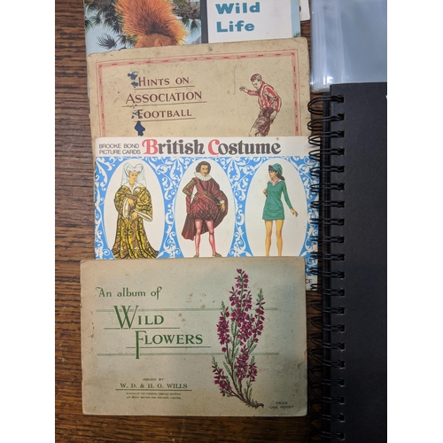 388 - Cigarette cards and tea card books and loose cards and in plastic wallets with French game cards Loc... 