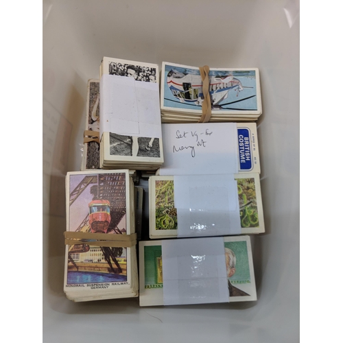 388 - Cigarette cards and tea card books and loose cards and in plastic wallets with French game cards Loc... 