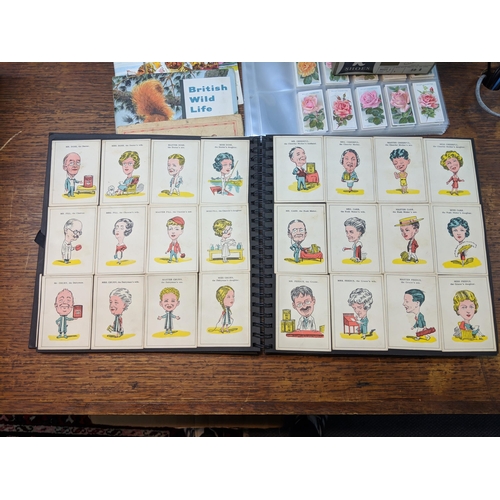 388 - Cigarette cards and tea card books and loose cards and in plastic wallets with French game cards Loc... 