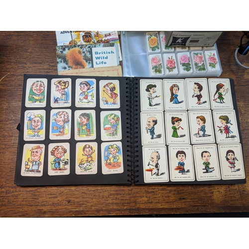 388 - Cigarette cards and tea card books and loose cards and in plastic wallets with French game cards Loc... 