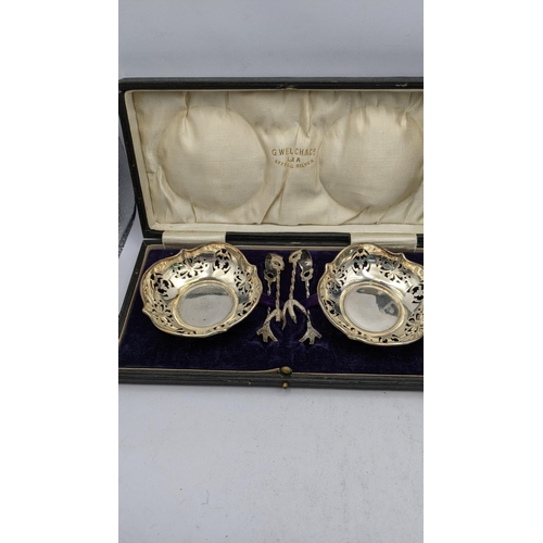 429 - A boxed set of pierced sugar bowls and tongs hallmarked Birmingham 1919, together with a silver eggc... 