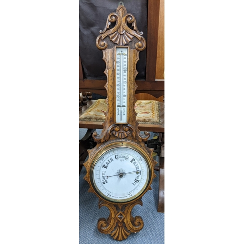 449 - An early 20th century oak carved wall hanging aneroid barometer Location:RWM