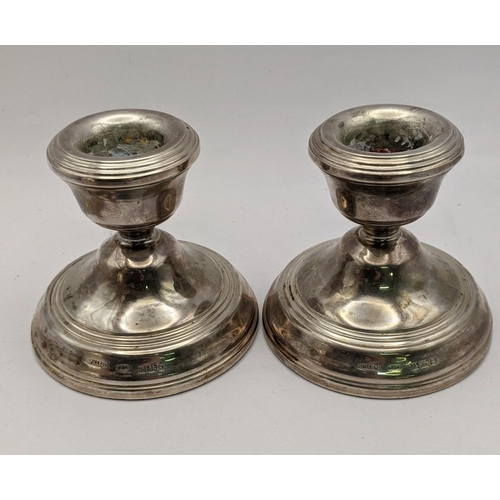 451 - A pair of silver candlestick holders hallmarked Birmingham 1978 together with a white metal milk jug... 