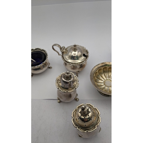 452 - Mixed silver condiment to include a pair of pepper pots, one A/F, silver salts, a mustard pot and a ... 