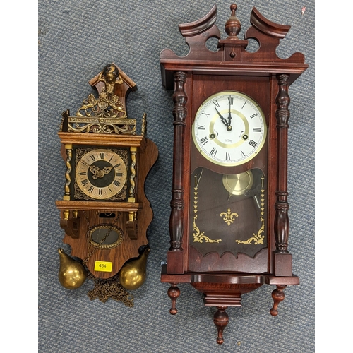 454 - A reproduction of a Dutch Stohl wall hanging clock having pierced gilt metal spandrels and in an oak... 