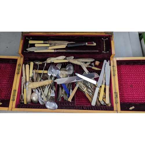 503 - An Edwardian mahogany canteen of mixed silver plated cutlery having an inset brass plaque and boxwoo... 