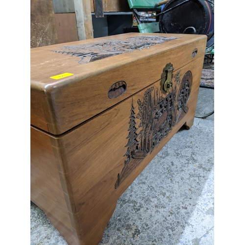 421 - An Oriental carved wooden camphor chest with brass catch and lock 51cm x 90.5cm x 44cm Location:G