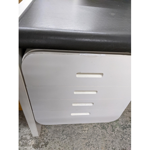 433 - An Art Deco style kneehole desk, white finished effect, black leatherette top over four side drawers... 