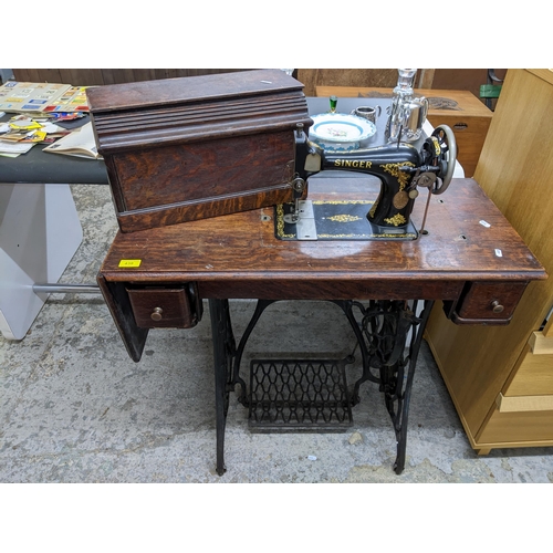 439 - An iron framed and oak cased trestle Singer sewing machine serial number F3950503 Location:G