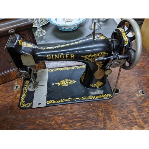 439 - An iron framed and oak cased trestle Singer sewing machine serial number F3950503 Location:G