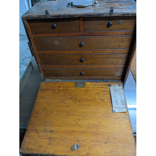 298 - An oak engineer's tool chest with two short and three long drawers with sliding front, containing va... 