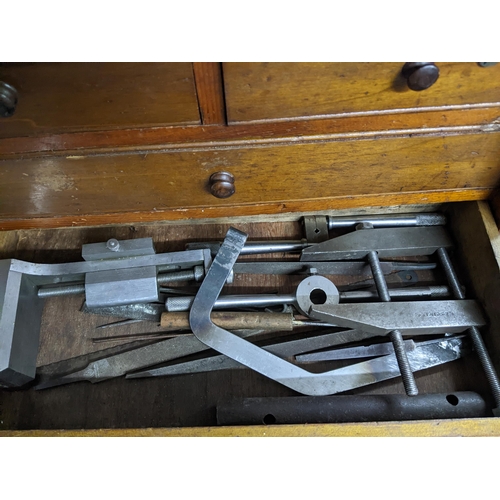 298 - An oak engineer's tool chest with two short and three long drawers with sliding front, containing va... 